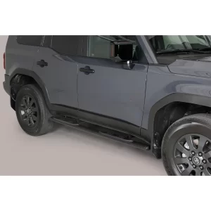 Passenger-side view of a 2025 Toyota Land Cruiser 250 in dark grey, equipped with black oval-profile side steps mounted below the doors to support safe entry and exit.