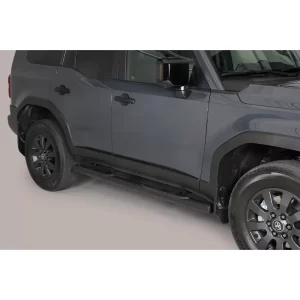 Side view of a dark gray 2025 Toyota Land Cruiser 250 showing black compact side steps installed below the doors, designed to assist entry and exit from the vehicle.