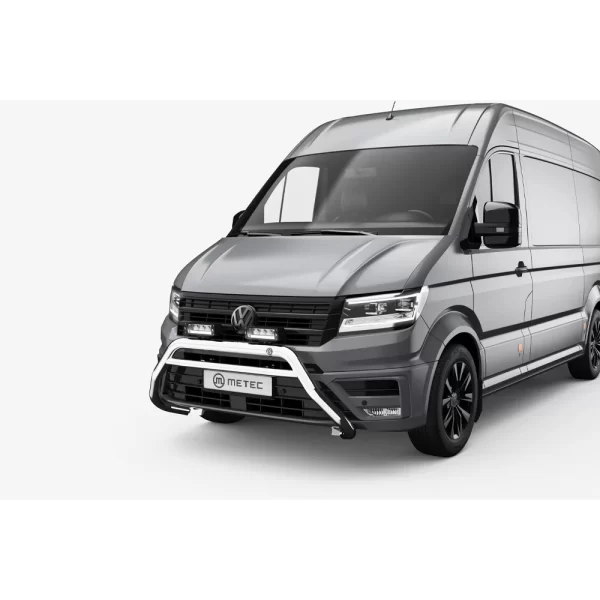 This image shows the bull bar fully installed on the front of a grey MAN TGE van. Mounted low on the front bumper, the polished stainless steel bull bar wraps protectively around the license plate area and houses two LED driving lights on the horizontal top bar. The installation appears precise, complementing the van’s design. The bull bar adds rugged, commercial-style protection while giving the vehicle a more commanding and ready-for-work appearance.