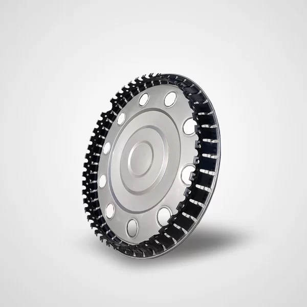 Back side of a 16-inch stainless steel hubcap, showing the black circular grip ring integrated along the inner edge. The silver metal surface features evenly spaced round holes forming a ring near the outer perimeter. The grip system is made of a flexible, toothed black structure that secures the hubcap firmly to the wheel.