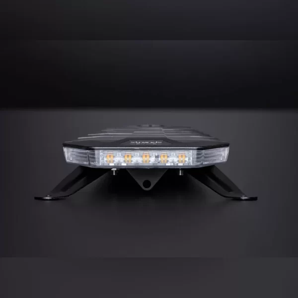 Low-profile amber LED lightbar viewed from the short side. Its transparent front lens reveals eight individual amber LEDs arranged in a straight line. The outer shell is black with sharp angles and a smooth, matte finish. It is mounted on two sturdy, angled black metal brackets that elevate it slightly from the surface.